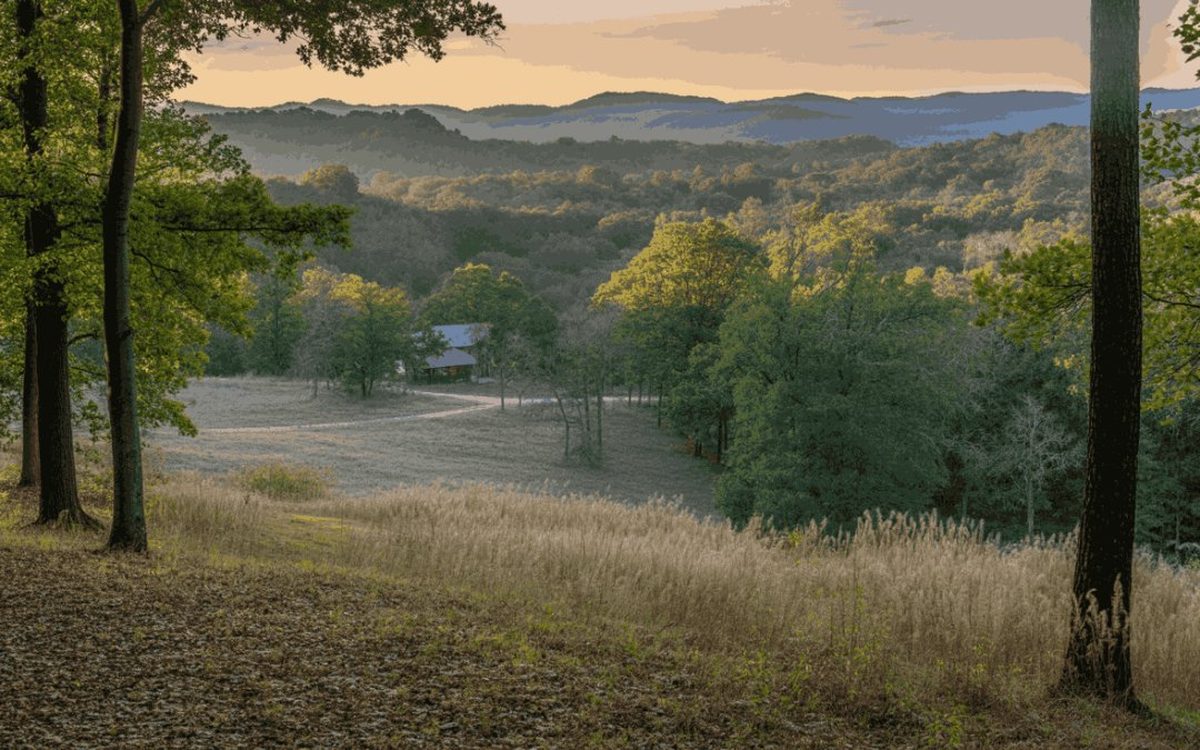Golden-hour overlook of rolling Pickens County, SC pasture and cabin